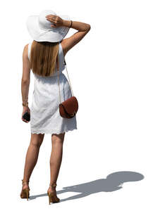 cut out woman in a white summer dress and hat standing