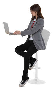 cut out woman sitting on a barstool and working with laptop
