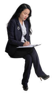 cut out asian businesswoman sitting and taking notes