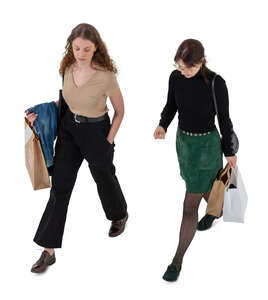 two cut out women with shopping bags walking seen from above