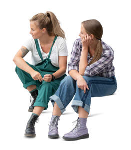 two cut out women sitting on the stairs