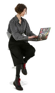 cut out young woman working with laptop sitting at a bar counter