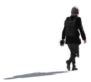 cut out backlit woman wearing an autumn overcoat walking