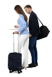 cut out man and woman standing at the hotel reception and filling papers