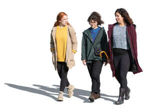 three cut out women walking on sunny autumn day