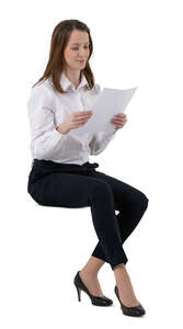 cut out female office worker sitting and reading some papers