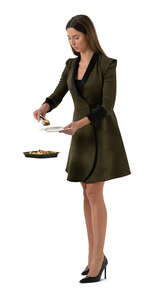 cut out woman standing at a buffet table and taking herself some food