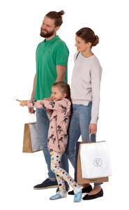 cut out family with shopping bags standing and pointing at smth