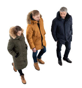 three cut ouut people in winter coats walking seen from above