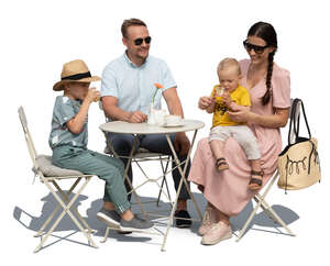 family with two kids sitting in a cafe on a summer day