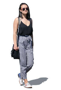 asian woman in striped pants walking