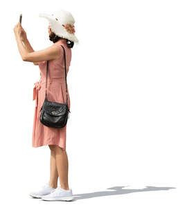 asian woman with a hat standing and taking a picture