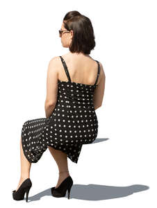 woman in a dotted summer dress sitting