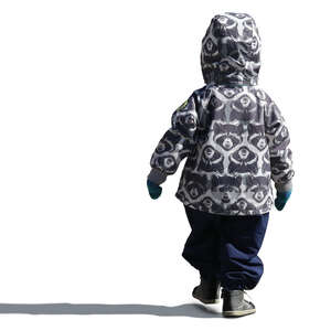 small boy in a hooded winter jacket walking