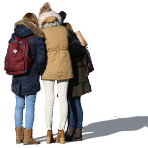 three girls in overcoats standing in a group