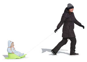 woman pulling a sledge with his baby boy