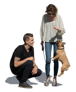 cut out man and woman playing with a dog