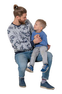 cut out little boy sitting on his fathers knee