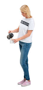 cut out woman standing and pouring herself coffee