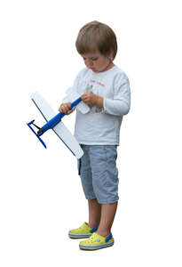 cut out little boy playing with a toy plane