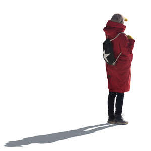 cut out backlit woman in a winter coat standing and looking