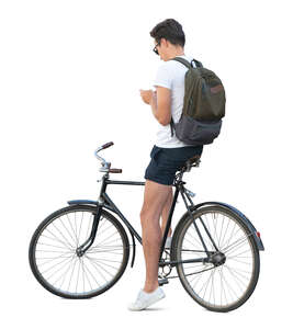 cut out young man stopping while riding a bike and texting