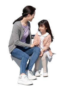 cut out asian mother and daughter sitting and talking