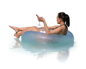 cut out woman relaxing in a pool on a floatie and drinking cocktails