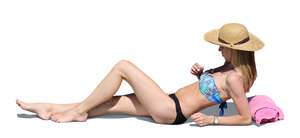 cut out woman lying on the beach and sunbathing