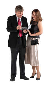 middle-aged couple standing in theatre and reading the program