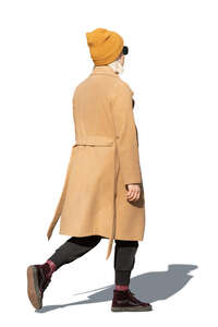 cut out woman in a brown overcoat walking