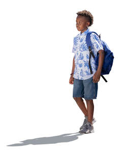 little backlit boy with a backpack walking