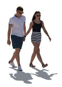 cut out backlit man and woman walking and holding hands