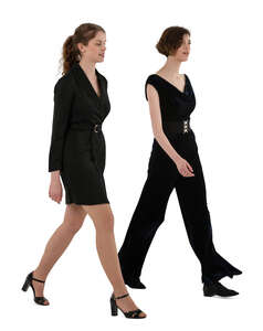 two cut out women in formal black party outfits walking