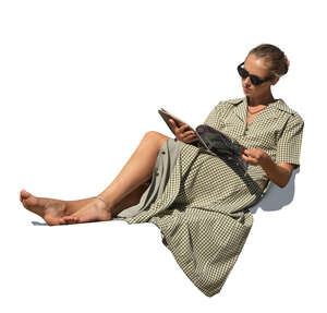 cut out woman sitting on reclining chair and reading a magazine