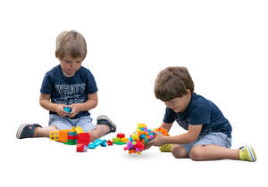 two cut out boys playing with constructor toys