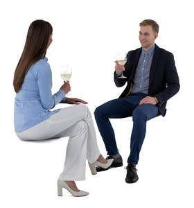 cut out man and woman sitting in a restaurant and drinking wine