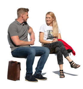 cut out man and woman sitting outside on a bench and talking