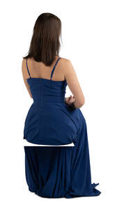 cut out woman in a blue evening gown sitting