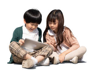 two cut out asian kids sitting and watching their ipad