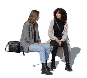 two cut out women sitting and talking