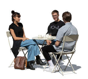 cut out group of three young people sitting in a street cafe