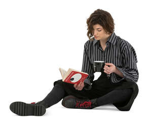 cut out woman sitting on the ground and reading a book