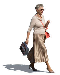 cut out elderly lady with a small shopping bag walking