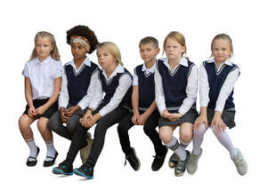 cut out group of school children sitting in a row