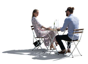 backlit cafe scene with man and womans drinking coffee and talking