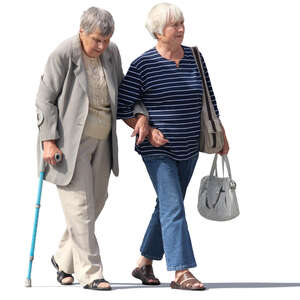 two elderly ladies walking arm in arm