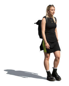 cut out woman in a black summer dress walking