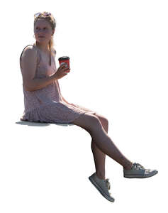 cut out woman sitting on the balustrade and drinking coffee