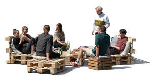 cut out group of young people relaxing in an outdoor cafe